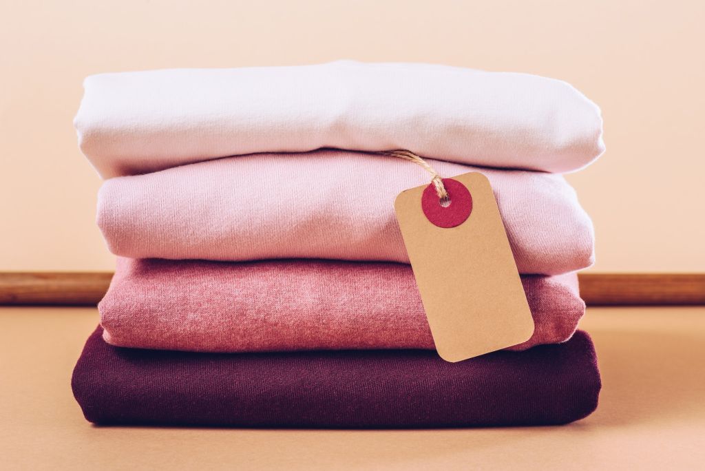 stylish pink women wear with sale tag on beige